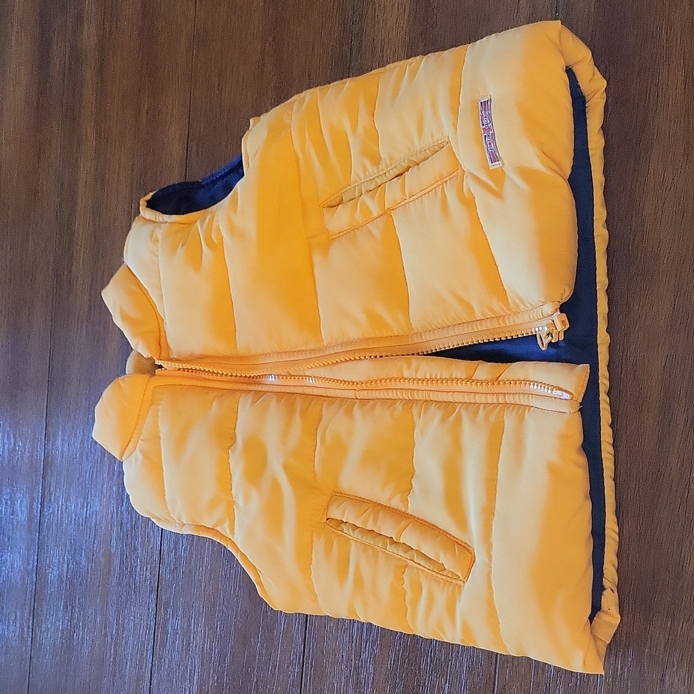 Yellow puffy vest.